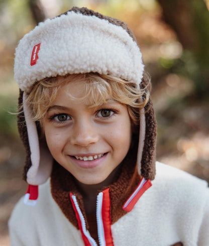Children's brown white teddy effect ushanka red detail Hello Hossy